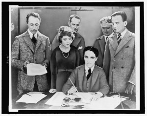 D.W. Griffith, Mary Pickford, Charlie Chaplin (seated) and Douglas Fairbanks at the signing of the contract establishing United Artists motion picture studio (LOC)
